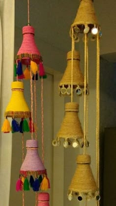 several different types of bells hanging from the ceiling