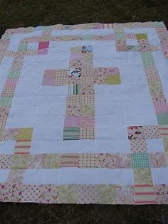 a quilted table topper sitting on the grass