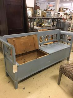 a blue bench sitting in front of a wooden chair