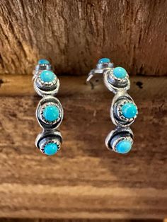 Indulge in the stunning beauty of these Native American Navajo Hoop Turquoise Earrings. Handcrafted with genuine Sterling Silver and Turquoise Stone, each pair is a unique masterpiece. Perfect as a gift, they come in a beautiful gift box. Elevate your style and connect with the rich culture and history of the Navajo people. - Five turquoise cabochons set in sterling silver bezels traverse each of these hoop earrings, perfect for everyday wear.  - Material: 925 sterling silver, genuine turquoise Turquoise Hoop Earrings, Turquoise Hoops, How To Make Necklaces, Cute Bracelets, Genuine Turquoise, Jewelry For Her, Native American Jewelry, Turquoise Earrings, Jewelry Earrings Hoops