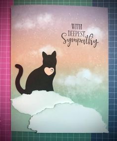 a card with a black cat sitting on top of a snow covered hill and the words, with deepest sympathy