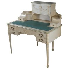 an old fashioned desk with drawers and a mirror on the top, is painted white