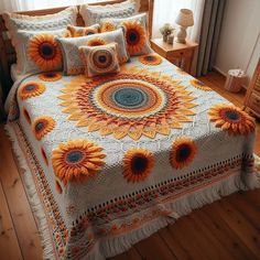 a bed with sunflowers on it in a room next to a wooden floor