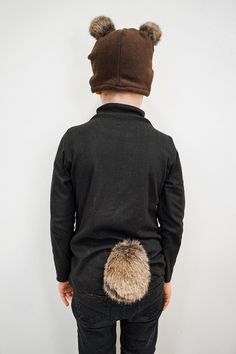 the back of a child's jacket with fur pom poms on it