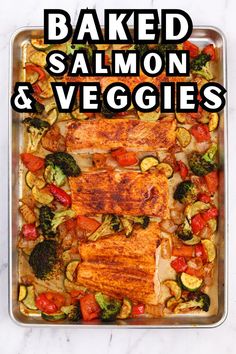 baked salmon and veggies in a baking pan with the words baked salmon and veggies