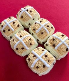 four crocheted cookies with chocolate chips on them are arranged in the shape of footballs