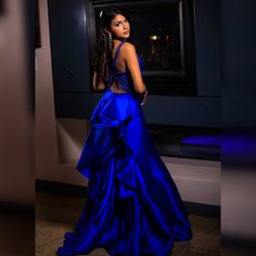 Royal Blue formal gown with ruffled back detail and tulle.  Top of dress has royal blue and silver beading detail and cross back. Glamorous Blue Ruffled Evening Dress, Glamorous Blue Evening Dress With Ruffles, Blue Ruffled Evening Dress For Gala, Royal Blue Ruffled Dress For Wedding, Blue Backless Prom Gown, Royal Blue Gown For Gala During Prom Season, Elegant Blue Ball Gown For Homecoming, Royal Blue Ruffled Evening Dress, Royal Blue Evening Gown With Sweep Train