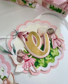 a pink and gold card with the letter e on it