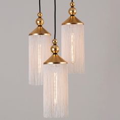 three light chandelier with fringes hanging from the ceiling