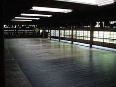 an empty room with wooden floors and windows