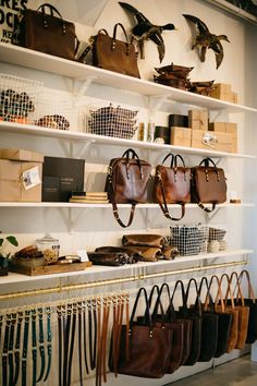 the shelves are filled with purses and bags