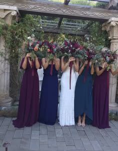 the bridesmaids are holding their bouquets together