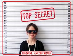 a woman wearing sunglasses and standing in front of a mug with the words top secret on it