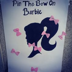 a sign that says pin the bow on barbie with pink bows around her head and an image of a woman's profile