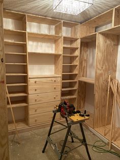 a workbench is being used to build shelves in a closet with plywood