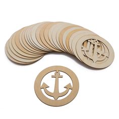 a pile of wooden coasters with an anchor