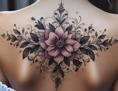 a woman's back with flowers and leaves on it