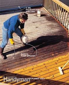 a man in blue shirt and yellow gloves painting a wooden deck