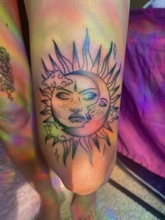 a sun and moon tattoo on the leg