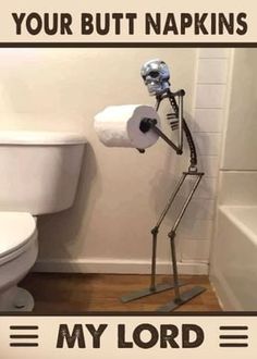 a skeleton toilet paper holder in a bathroom