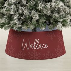 a red vase with white snowflakes and the word wallace on it