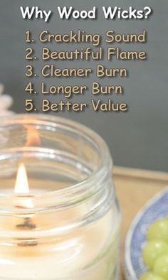 a candle sitting on top of a wooden table next to grapes and a plate with text that reads, why wood wicks?