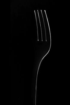 a black and white photo of a fork