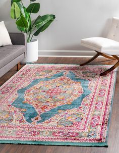 a living room area with a couch, chair and rug