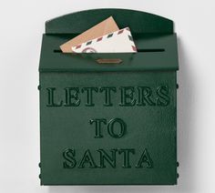 a green mailbox that says letters to santa written on the front, and an envelope sticking out of it