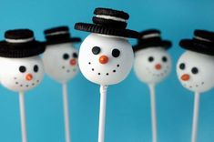 snowman cake pops with hats on them are ready to be eaten for the holiday