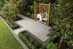 a woman sitting on a bench in a garden