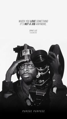 a black and white photo of a man holding a camera in front of his face