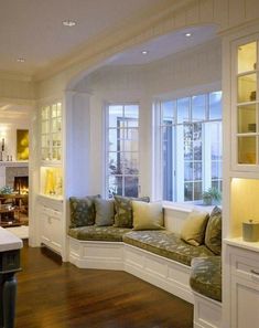 a living room filled with furniture and windows