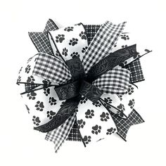 a black and white bow with paw prints on it