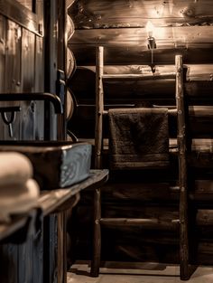 the inside of a log cabin with towels hanging on the rack and other items in the room