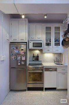 a kitchen with stainless steel appliances and white cabinets