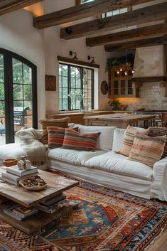 a living room filled with furniture and lots of windows