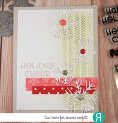 a holiday card with snowflakes on it next to some scissors and other crafting supplies