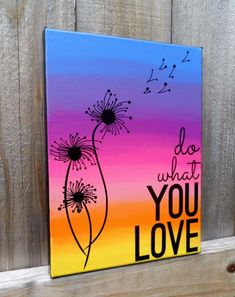 a painted canvas with the words do what you love and dandelions on it