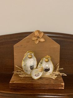 two oysters are sitting on top of a piece of wood with a flower in the center