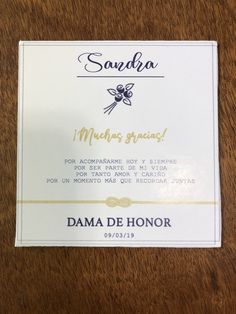 a close up of a business card on a wooden table with writing in spanish and english