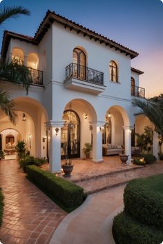 a large white house with lots of windows and balconies