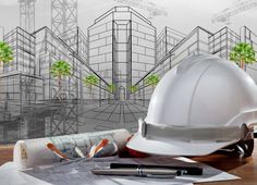 a white hard hat sitting on top of a wooden table next to construction drawings and tools