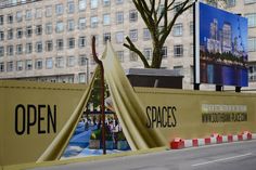 an open sign on the side of a road with a teepee tent in front of it