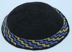 A stunning black knitted Kippah with a wide border in geometric ladder pattern of blue and brown. The color scheme of black and blue with brown is complementing each other and is enhancing its beauty. It is hand knitted from high-quality 100% cotton - threads of exceptional quality and appearance that make the Kippah durable, color fast and long-lasting. Wear this beautiful Kippah with pride and gain the respect from friends, family, and other members. Whether you are doing sports or sitting in Black Crochet Yarn Hat, Traditional Black Beanie Hat, Traditional Black Hat One Size Fits Most, Black Adjustable Crochet Hat, Adjustable Black Crochet Hat, Fitted Crochet Black Hat, Fitted Black Crochet Hat, Black Crochet Hat Adjustable Fit, Black Crochet Hat Adjustable