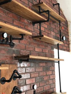 the shelves are made out of wood and pipe fittings, along with metal pipes