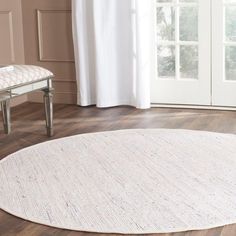 a large white rug is in the middle of a room