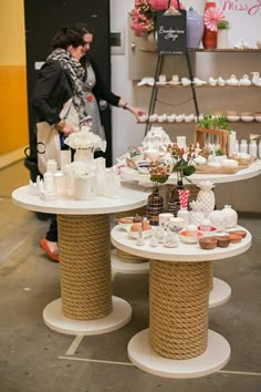 two tables that have different types of items on them and people looking at the table