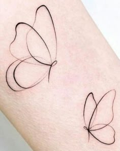 two butterfly tattoos on the thigh