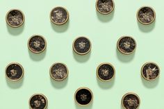 several different types of coins are arranged on a mint green background with black and white images